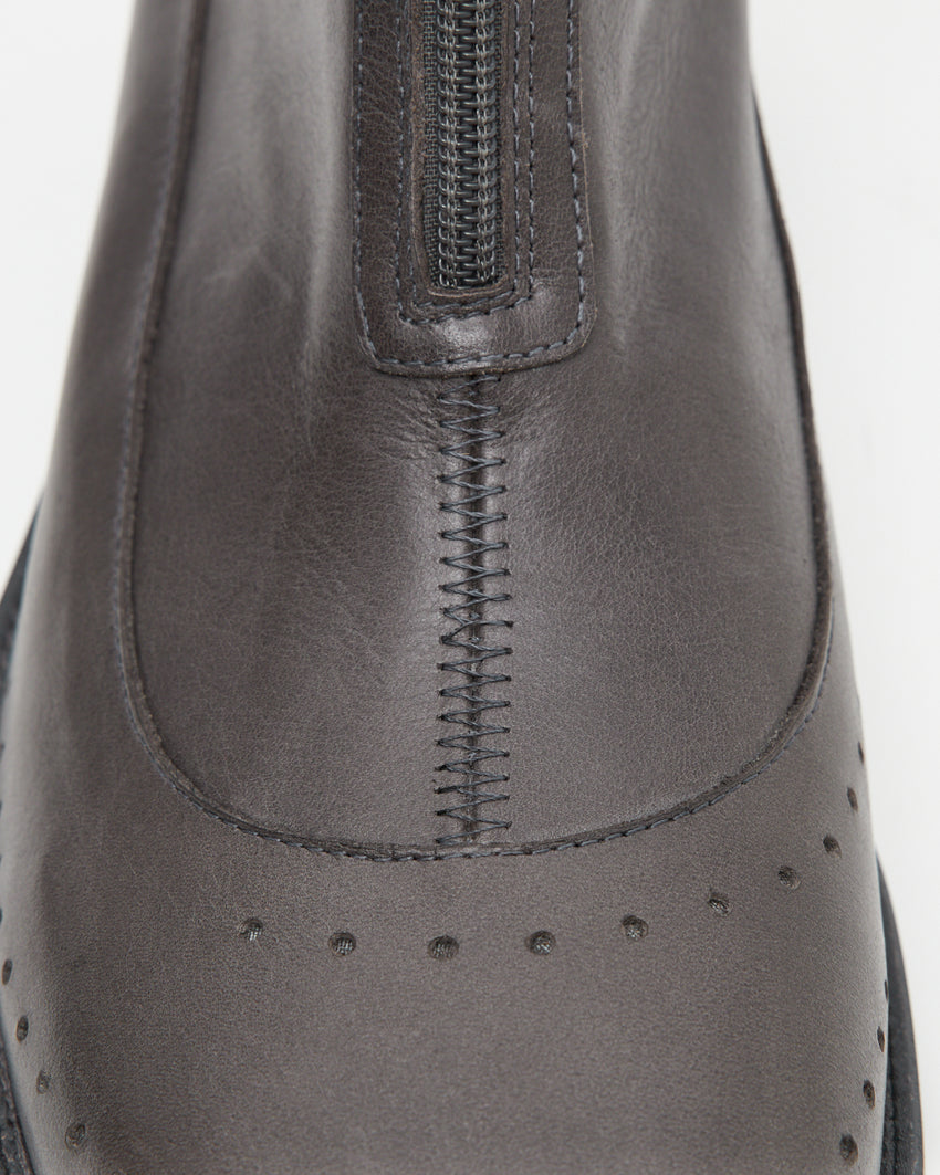 Extreme close-up of the Cove Boot Jeongli Grey top vamp showing the zip track and stitched brogue perforated seam