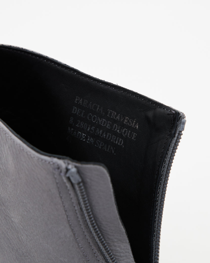 Close-up front view of a single Cove Boot Nubuck Ink Blue boot showing zipper and black interior lining with brand stamp