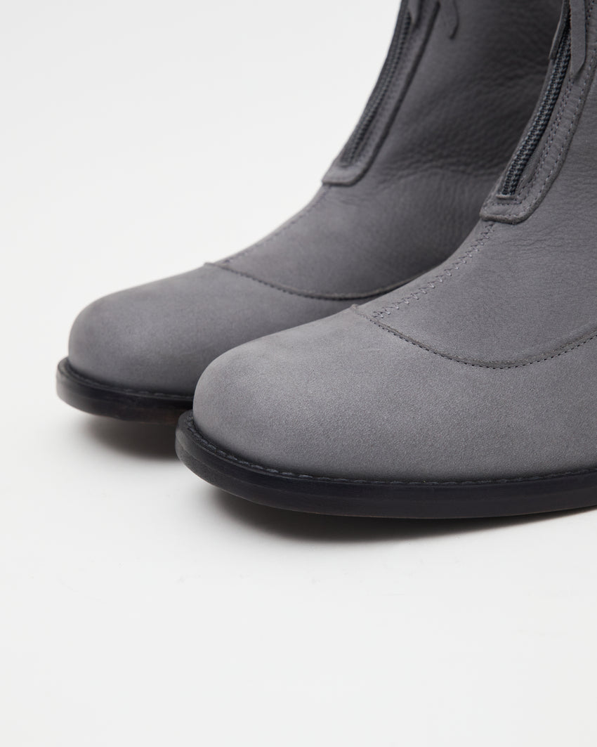 Pair of Cove Boot Nubuck Ink Blue boots, angled back view showing heels and zippers