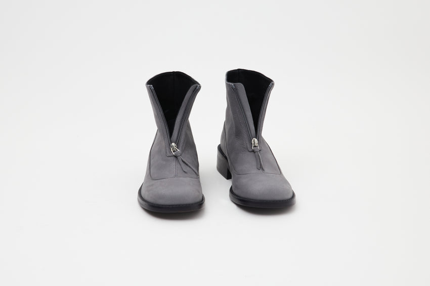 Pair of Cove Boot Nubuck Ink Blue boots, back view showing heels