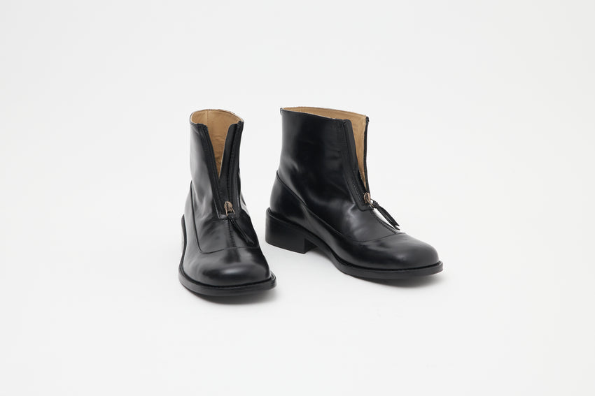 Pair of Cove Boots in pull-up leather black with the front zips open