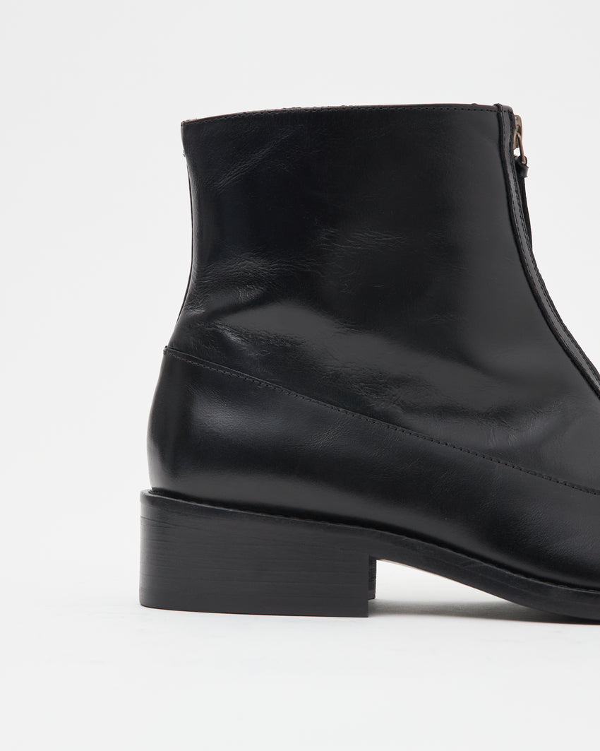 Close-up of the Cove Boot's ankle shaft and block heel in pull-up leather black