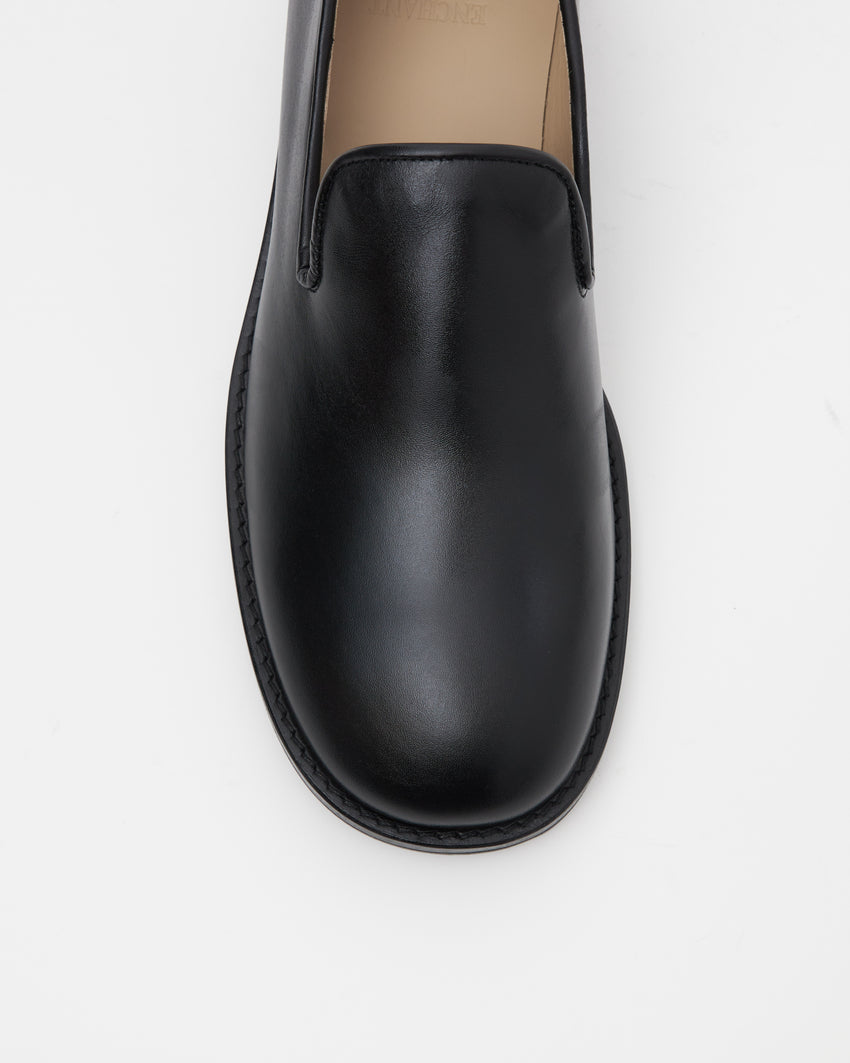 Top-down view of Legacy Slipper toe box in black calfskin leather.