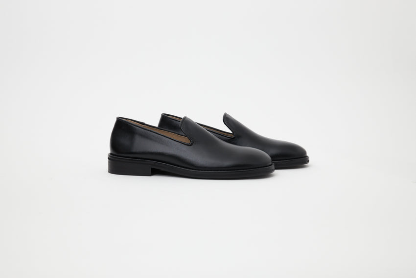 Pair of Legacy Slipper Calfskin Black loafers, angled side view