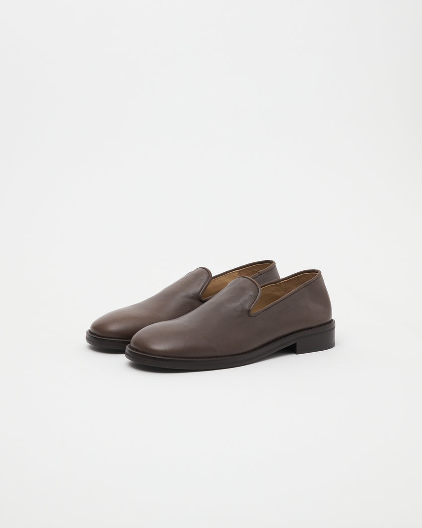 Three-quarter view of Legacy Slipper pair in brown oil nappa leather by Paracia.