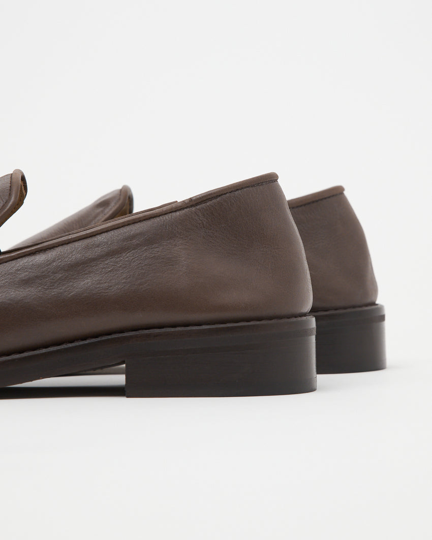 Close up rear view of Legacy Slipper in brown oil nappa leather, showing stacked heel construction.
