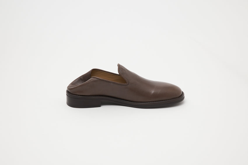 Side view of single Legacy Slipper in brown oil nappa leather, showing foldable heel.
