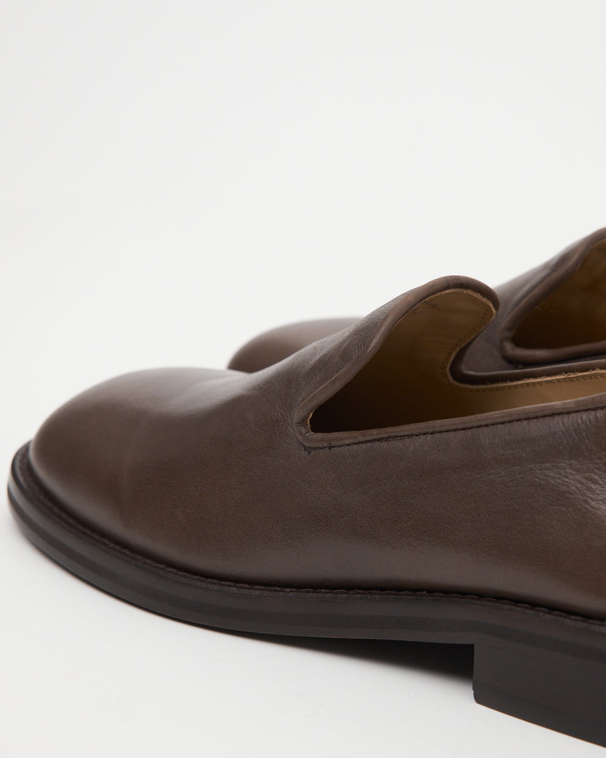 Close up shot of Legacy Slipper pair in brown oil nappa leather by Paracia.