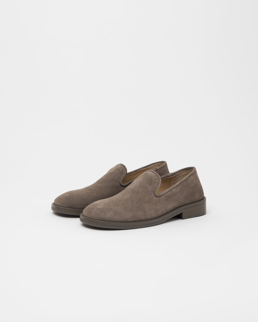 Pair of Paracia Legacy Slipper loafers in grey walnut suede, angled front view showing the tan interior lining
