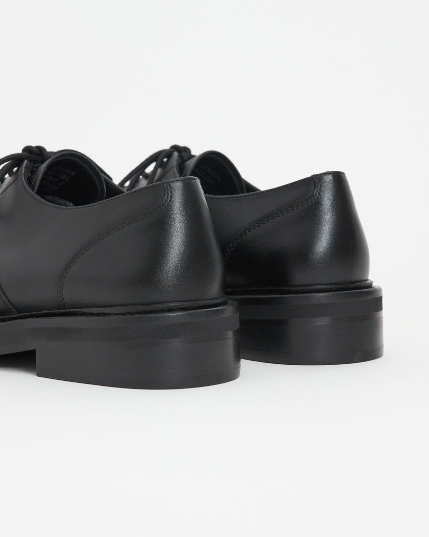 Back view of a pair of Mid-Heel Derby shoes in calfskin black