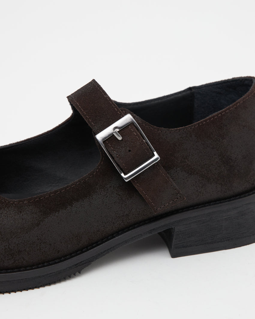 Close-up angled front view of a pair of Mary Jane Waxed Suede Deep Brown shoes showing buckle straps