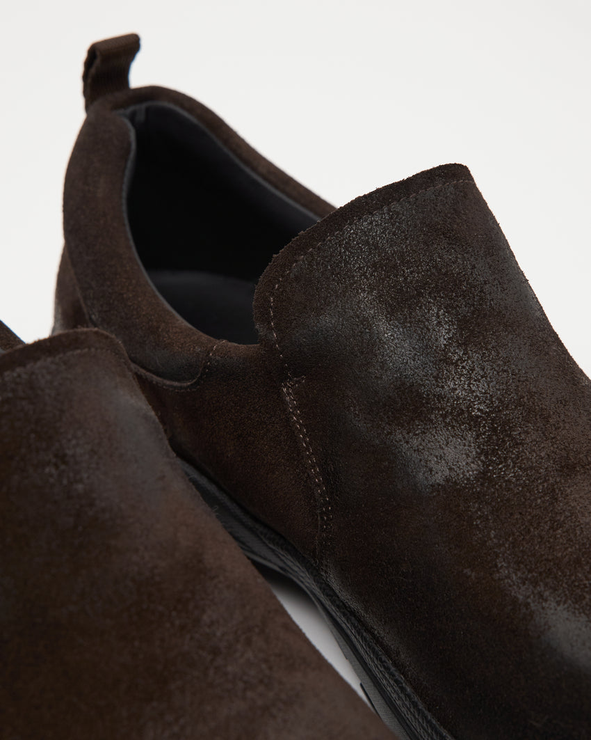 Close-up angled side view of a pair of Non-Safety Slip-on Waxed Suede Deep Brown shoes showing black interior collar