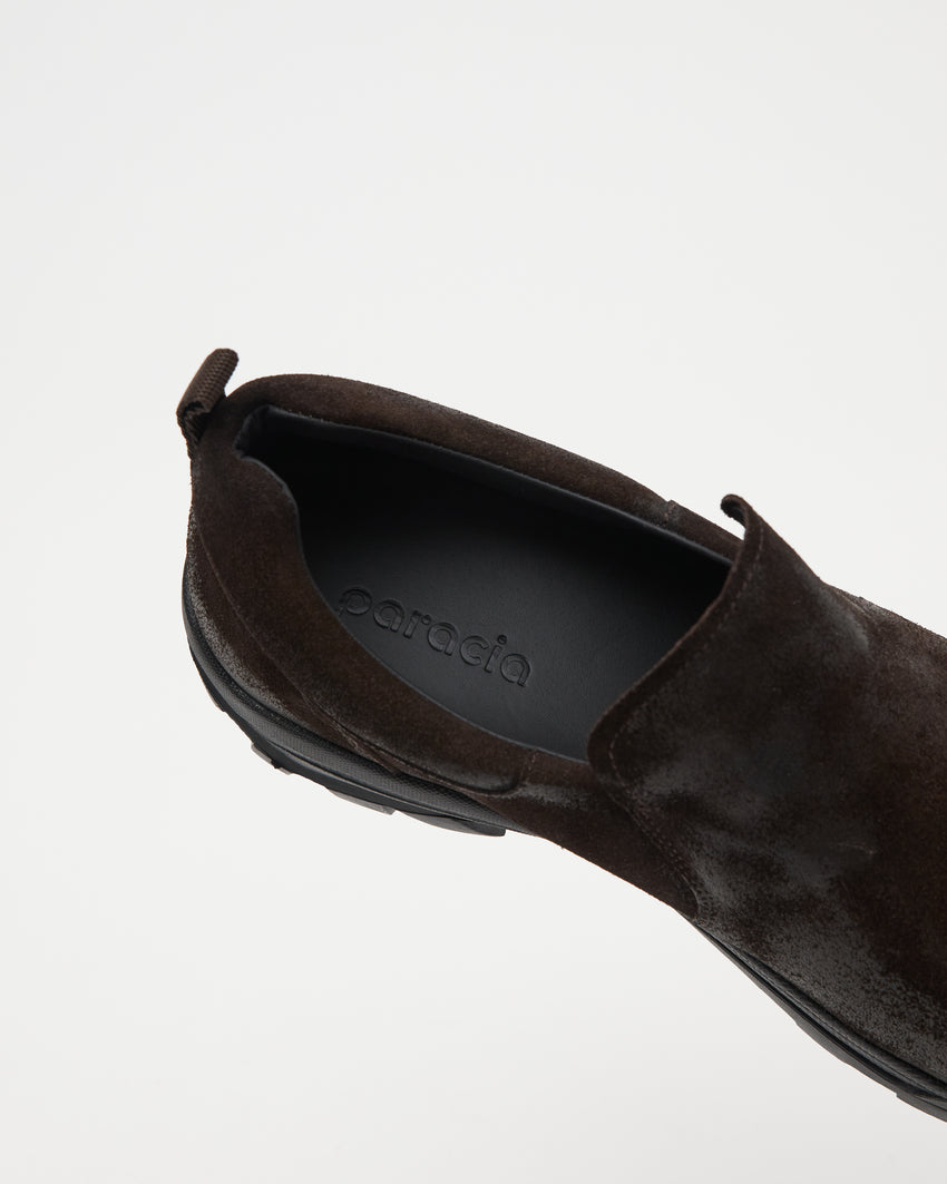 Close-up angled front-top view of a single Non-Safety Slip-on Waxed Suede Deep Brown shoe showing black interior collar