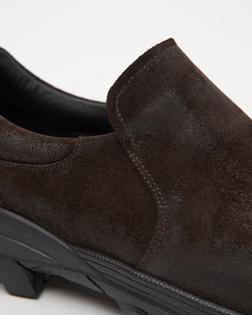 Close-up side view of a single Non-Safety Slip-on Waxed Suede Deep Brown shoe showing black interior collar and lugged sole