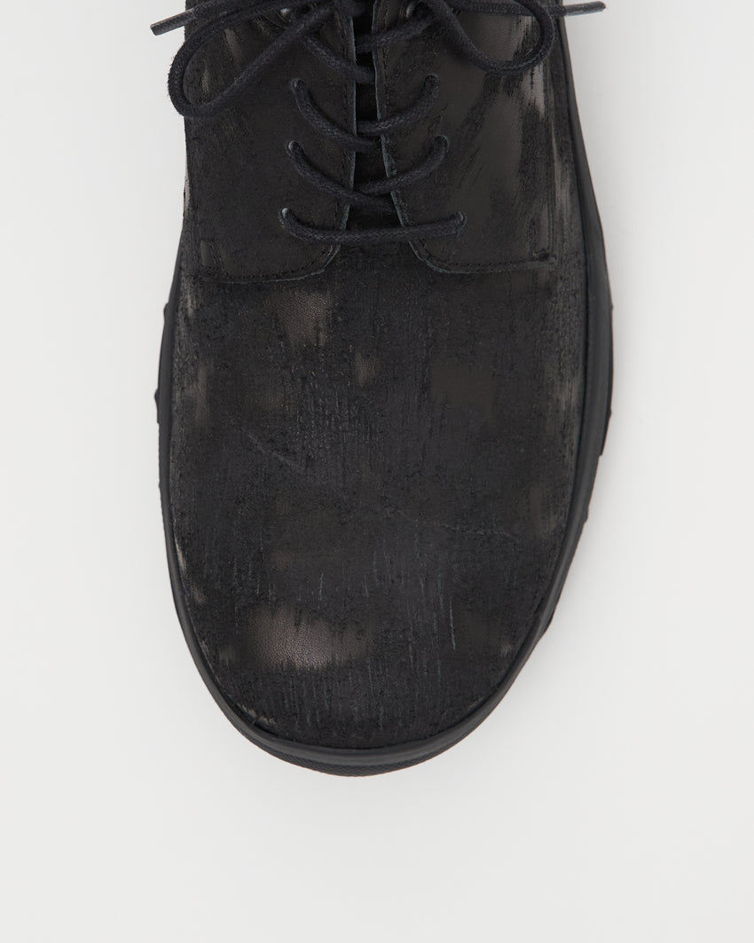 Close-up top-down view of a single Non-Safety Shoe Distressed Leather Black shoe showing laces and distressed texture