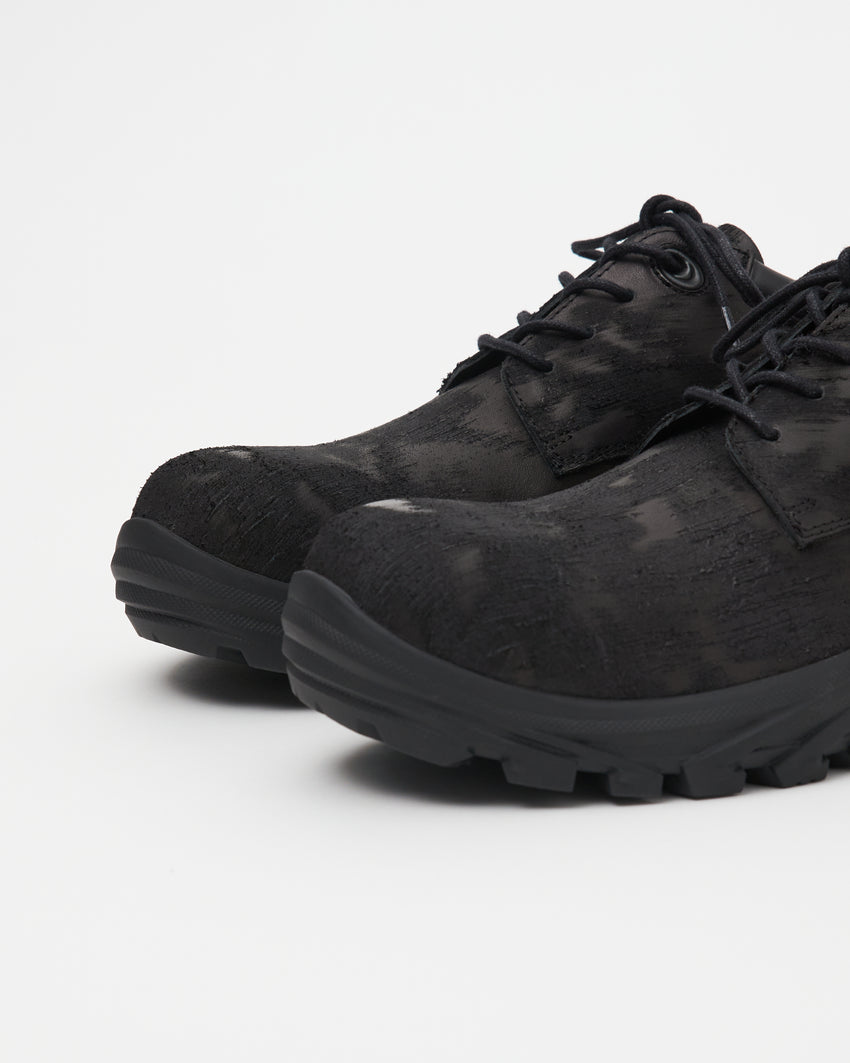 Close-up angled front view of a pair of Non-Safety Shoe Distressed Leather Black shoes showing laces and distressed texture