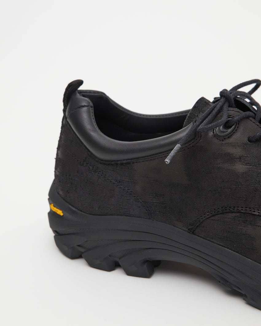 Close-up side view of a single Non-Safety Shoe Distressed Leather Black shoe showing the lugged sole