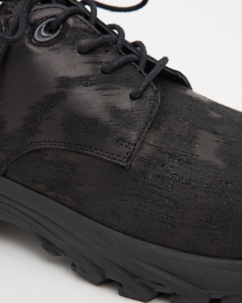 Close-up angled front view of a single Non-Safety Shoe Distressed Leather Black shoe showing laces and distressed texture