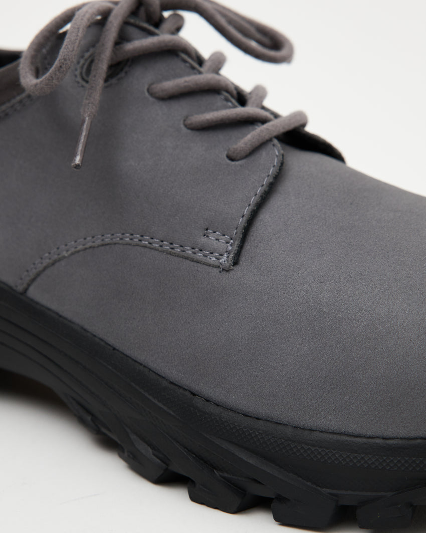Close-up angled front-top view of a single Non-Safety Shoe Nubuck Ink Blue shoe showing laces and lugged sole
