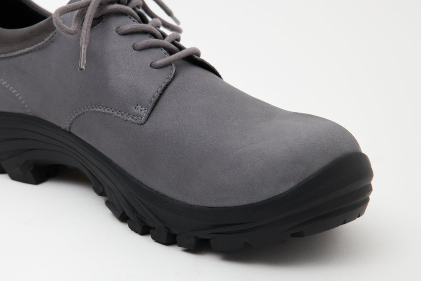 Close-up angled front view of a pair of Non-Safety Shoe Nubuck Ink Blue shoes showing laces and black interior collar