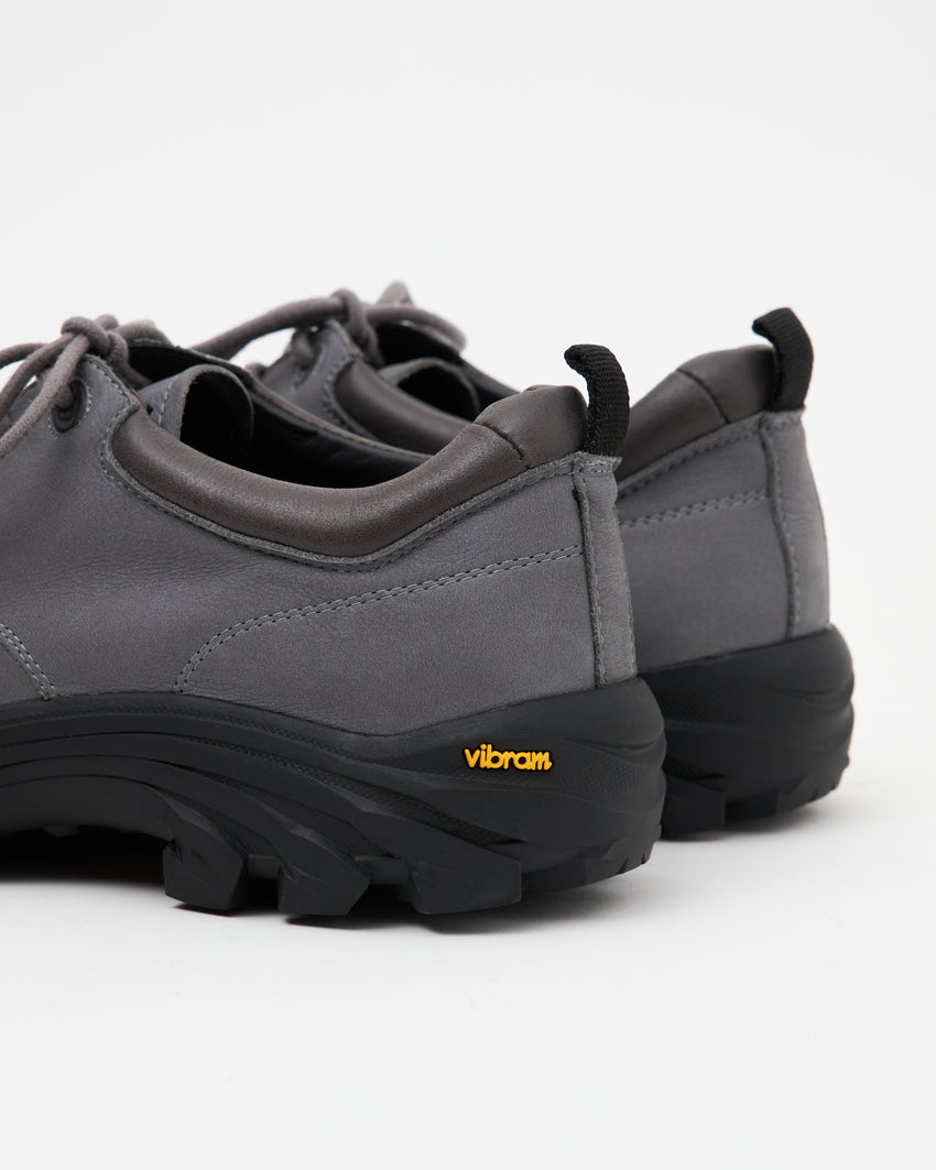 Close-up angled front view of a pair of Non-Safety Shoe Nubuck Ink Blue shoes showing laces and black interior collar