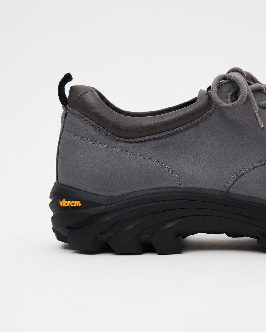 Close-up side view of a single Non-Safety Shoe Nubuck Ink Blue shoe showing lugged sole and Vibram sole tag