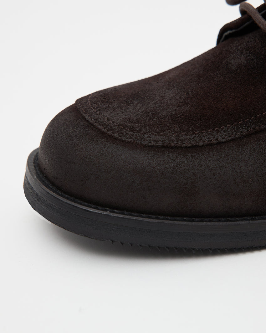 Close-up angled front view of a single Old Buster Waxed Suede Deep Brown shoe showing toe and suede texture