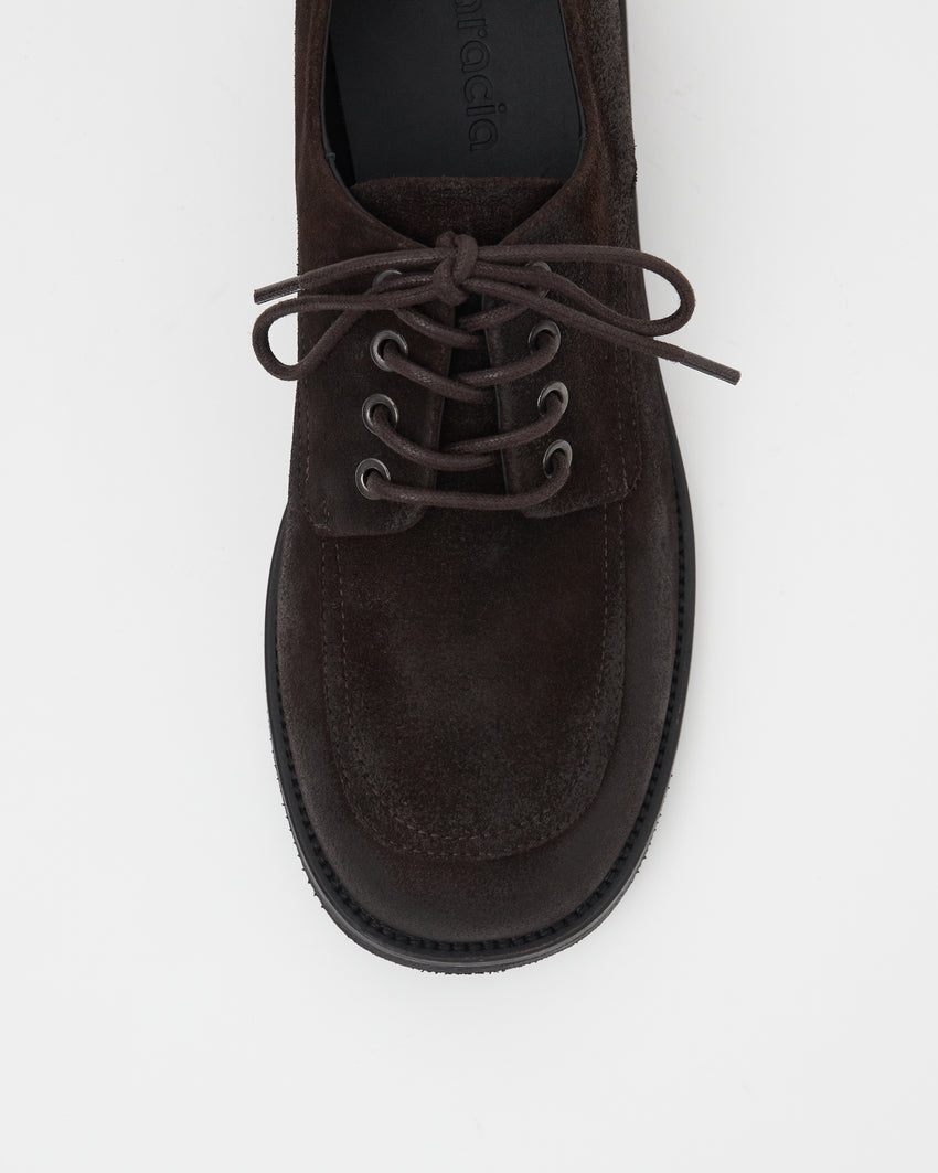 Close-up top-down view of a single Old Buster Waxed Suede Deep Brown shoe showing laces
