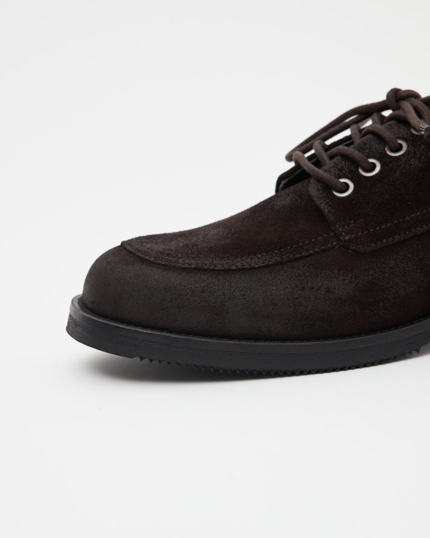 Close-up angled front view of a pair of Old Buster Waxed Suede Deep Brown shoes showing laces and suede texture