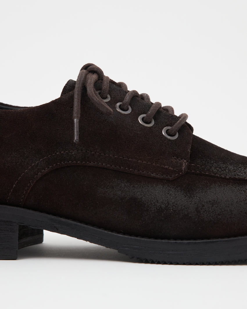 Close-up side view of a single Old Buster Waxed Suede Deep Brown shoe showing laces and suede texture